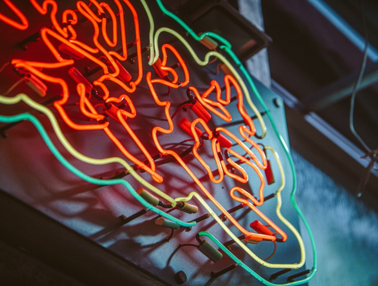 Modern heritage preservation workshop with traditional neon sign being restored