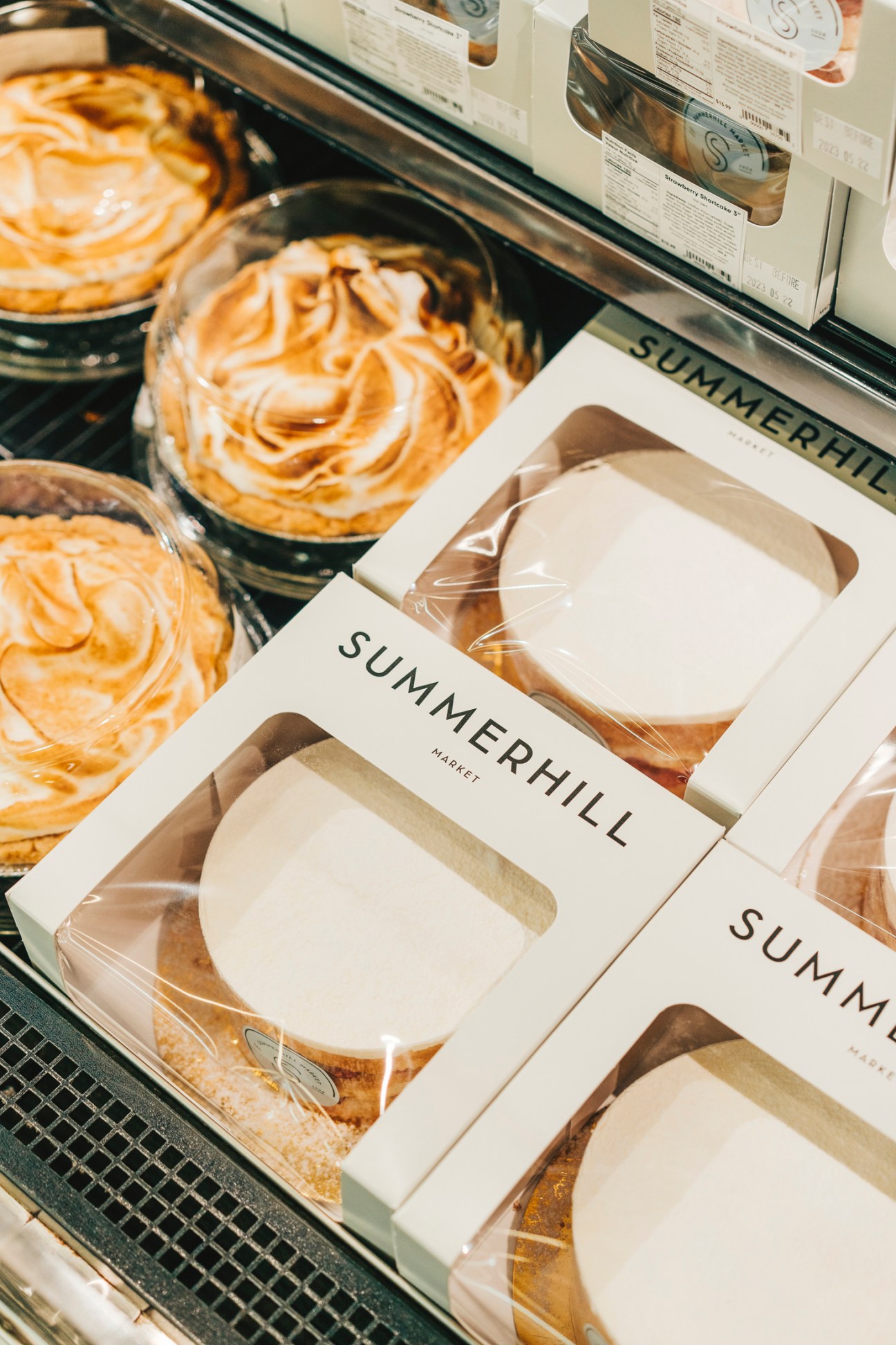 Neatly arranged packaged baked goods with Summerhill branding in white boxes with clear windows