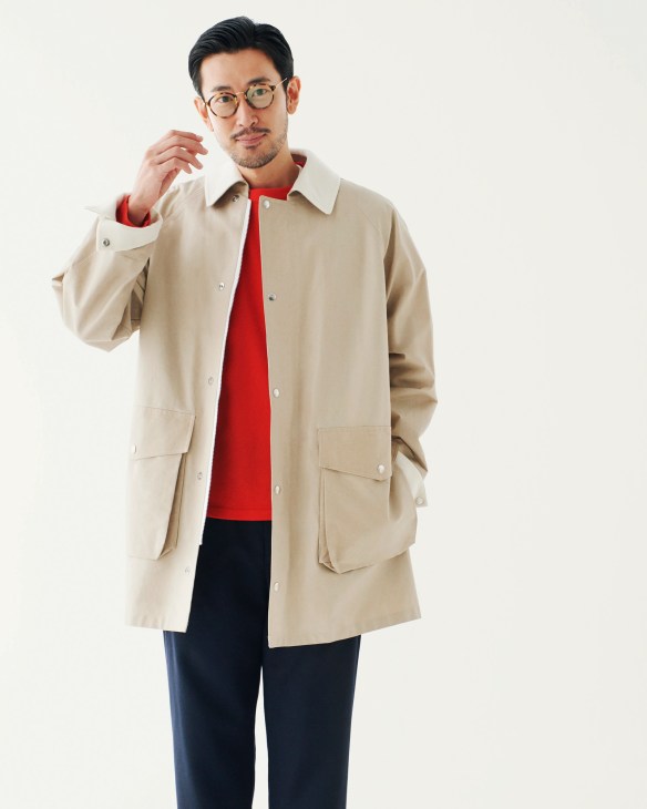 Man wearing Aton jacket, Comoli jumper, John Smedley trousers and Ray-Ban glasses