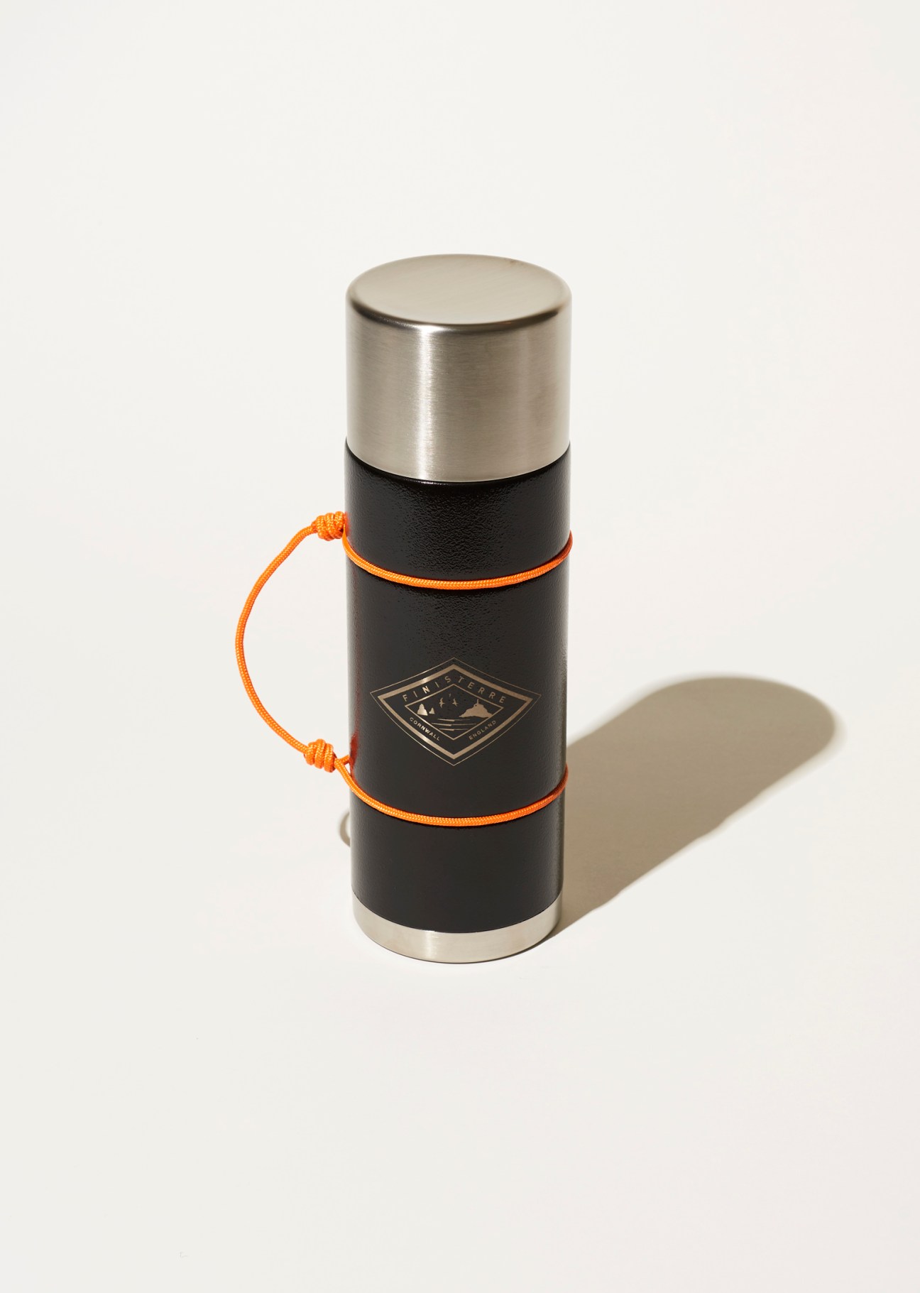 Mizu and Finisterre collaborative flask with black body, stainless steel cap and orange paracord