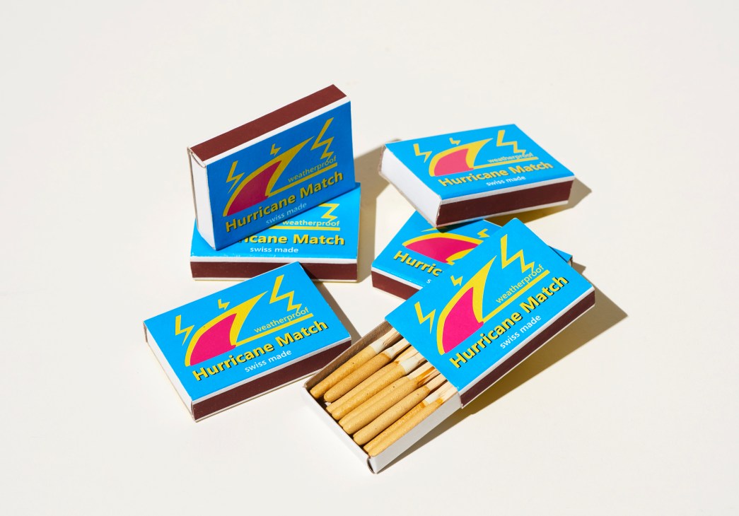 Four matchboxes with blue labels featuring hurricane graphics and yellow lightning bolt designs