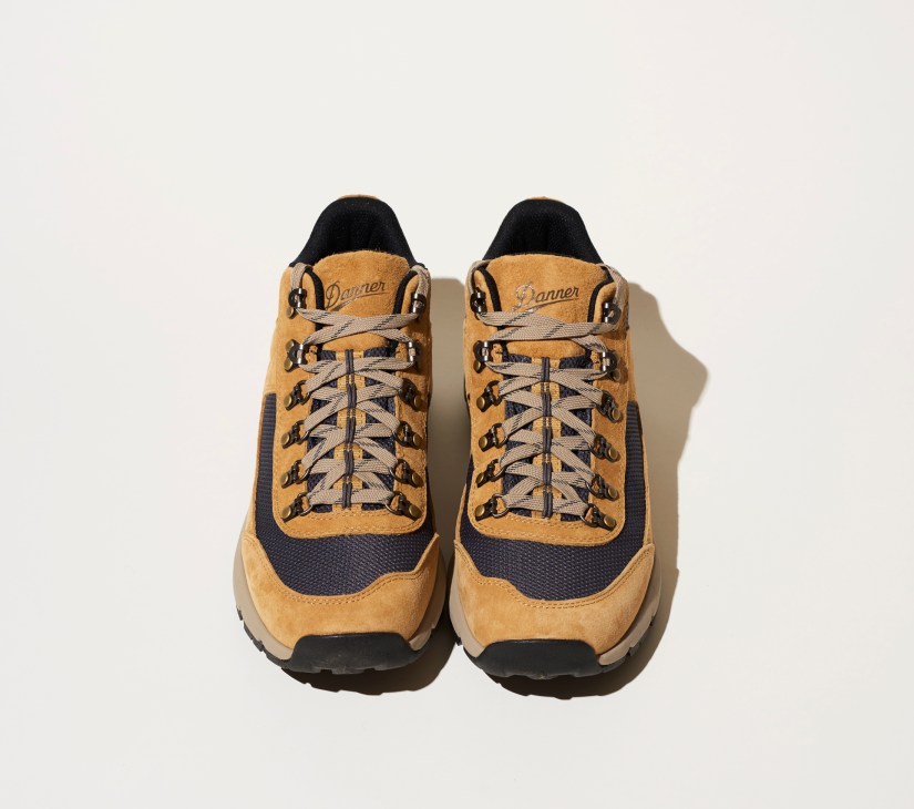 Pair of tan and navy Danner South Rim 600 hiking boots with rugged soles on white background
