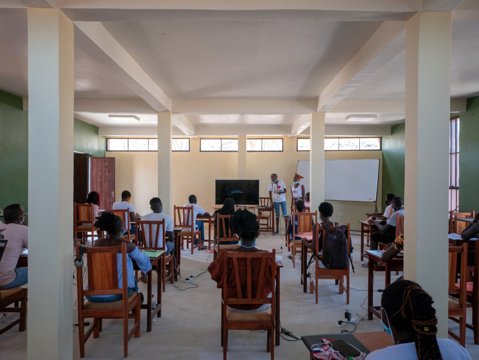 Interior classroom at Startup Lions Campus showing students at wooden desks with modern teaching facilities