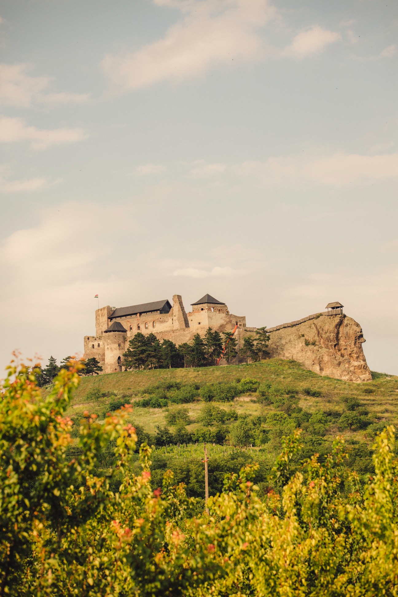 Boldogko castle perched on hilltop with medieval stone walls and towers surrounded by green landscape