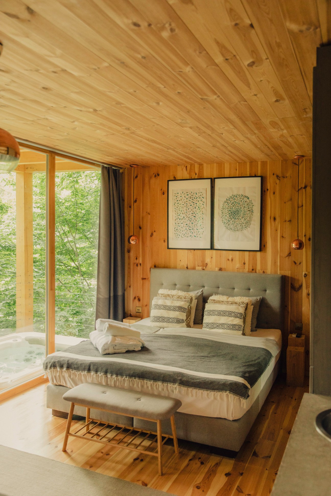 Cabin balcony with hot tub overlooking wooded hills in Noszvaj village