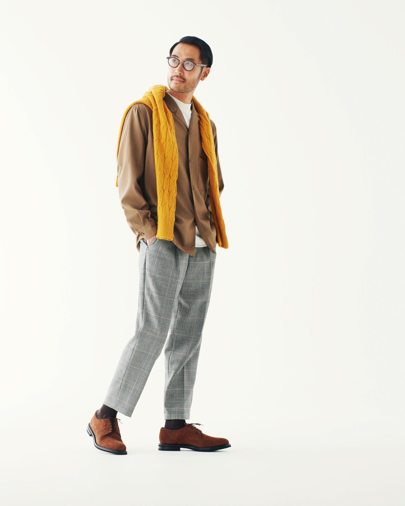 Man wearing Herno jacket, Eleventy polo shirt, and Giabs Archivio shorts with brown suede shoes and yellow scarf.