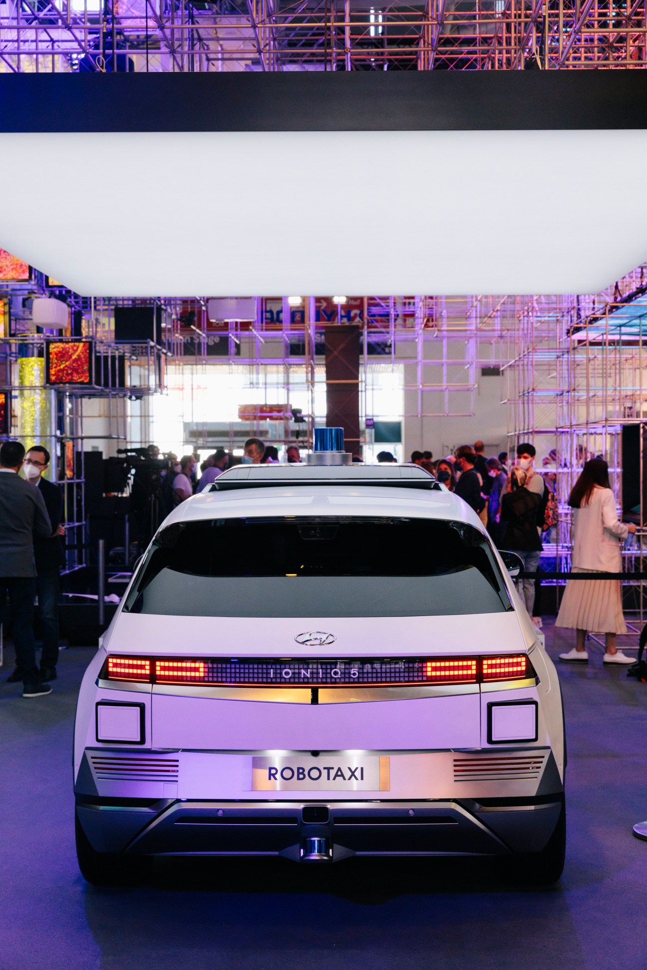 Hyundai Ioniq 5 robo-taxi concept vehicle on display at IAA Mobility motor show with visitors in background