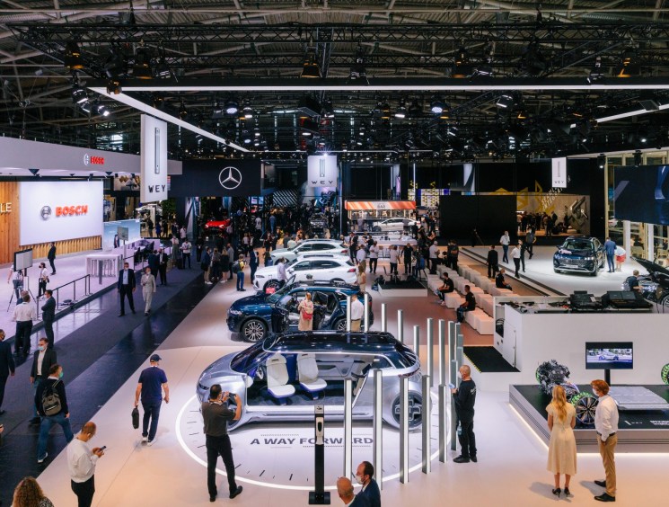 Busy Mercedes-Benz and Bosch exhibition hall at a major auto show.