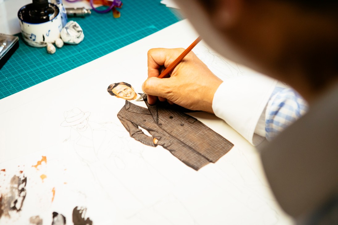Hand drawing a fashion illustration of a man in a checkered suit with colored pencil