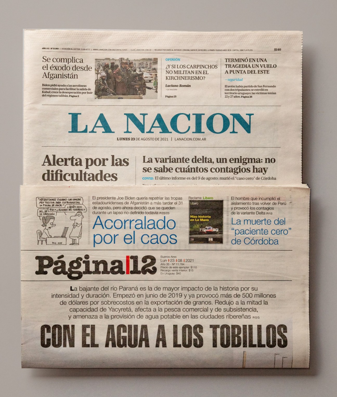 Front pages of Argentine newspapers La Nación and Página 12 displayed together.
