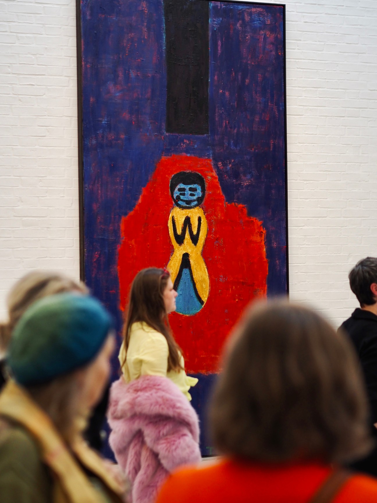 People viewing Tal R's painting Lillen at Kunsten Museum of Modern Art showing figure in red against blue background