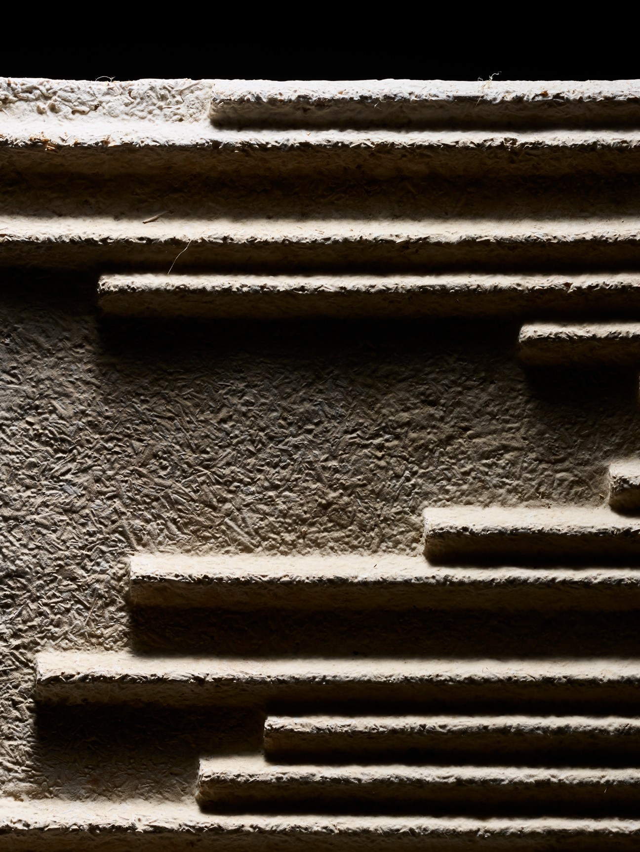 Textured acoustic panels made from hemp hurd and mushroom mycelium in stacked formation