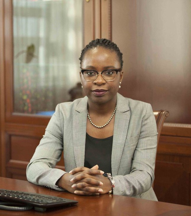 Vera Daves, Angola's first female finance minister, seated at a desk in professional attire.