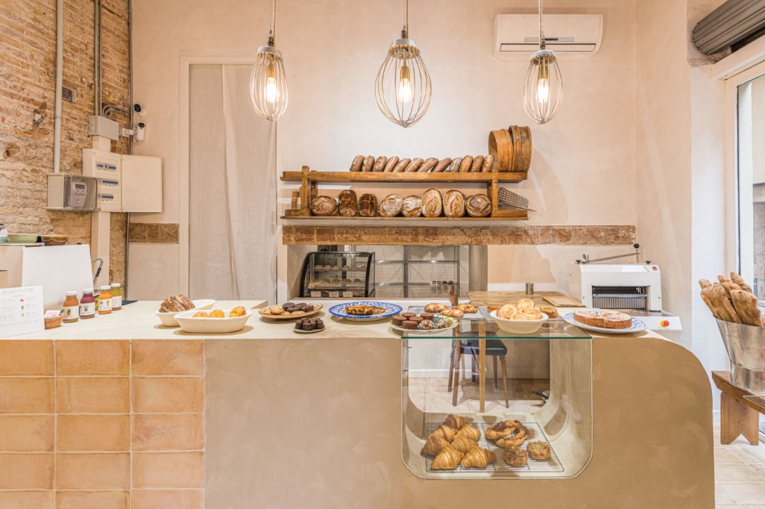 Display case showing Argentine pastries including croissants and baked goods at Coush Armó bakery