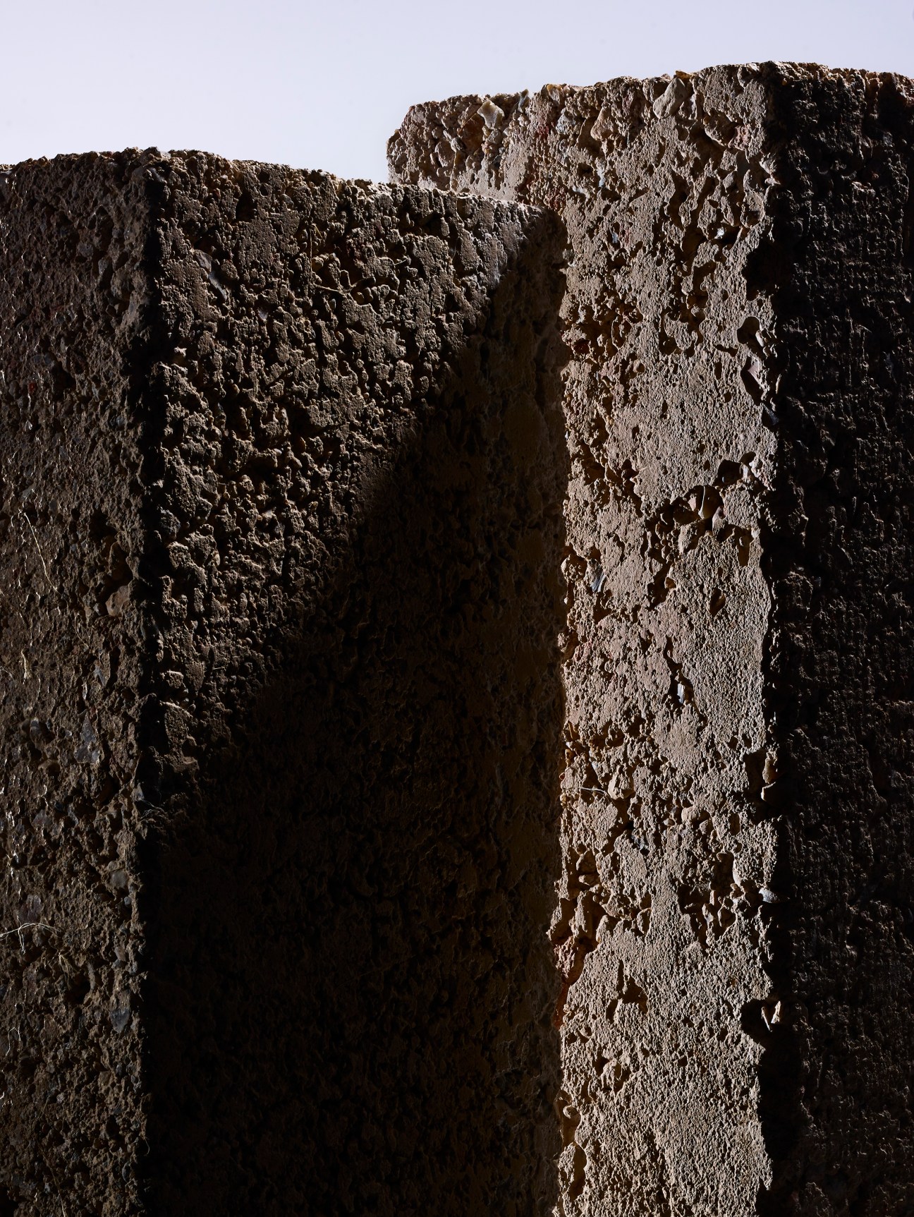 Textured brown silt brick material with rough, porous surface showing natural aggregate composition