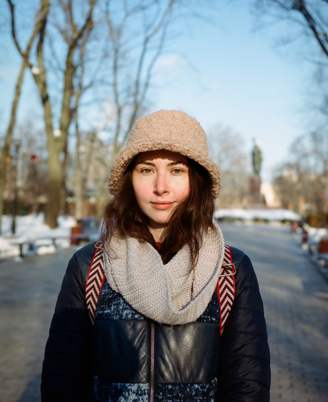 Student at Taras Shevchenko University wearing winter clothing and scarf on campus