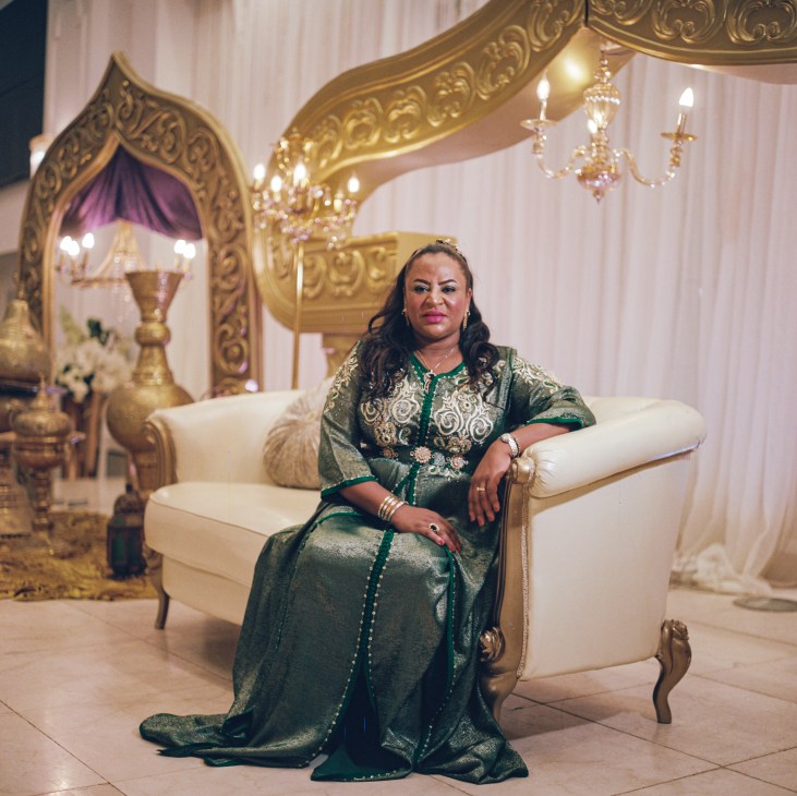 Fatima Alhomsa, Libya's most famous wedding singer, seated in ornate chair wearing elaborate green traditional dress