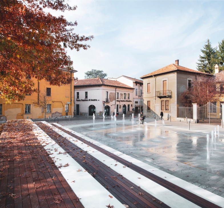 Modern urban plaza with water fountains and historic buildings in Milan designed by Openfabric