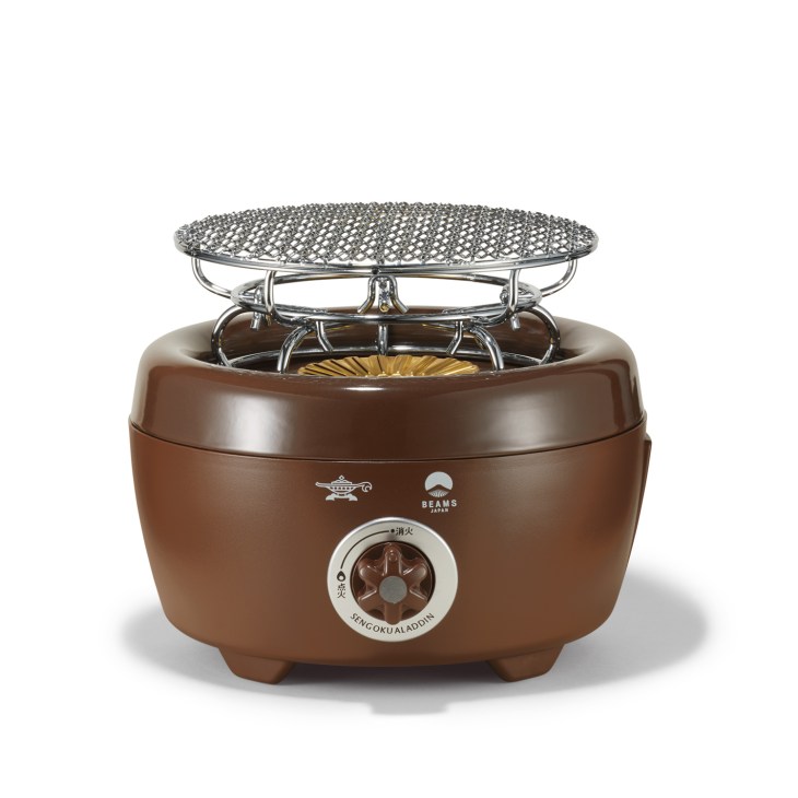 Brown Sengoku Aladdin portable gas cooker with mesh grill top and control dial.