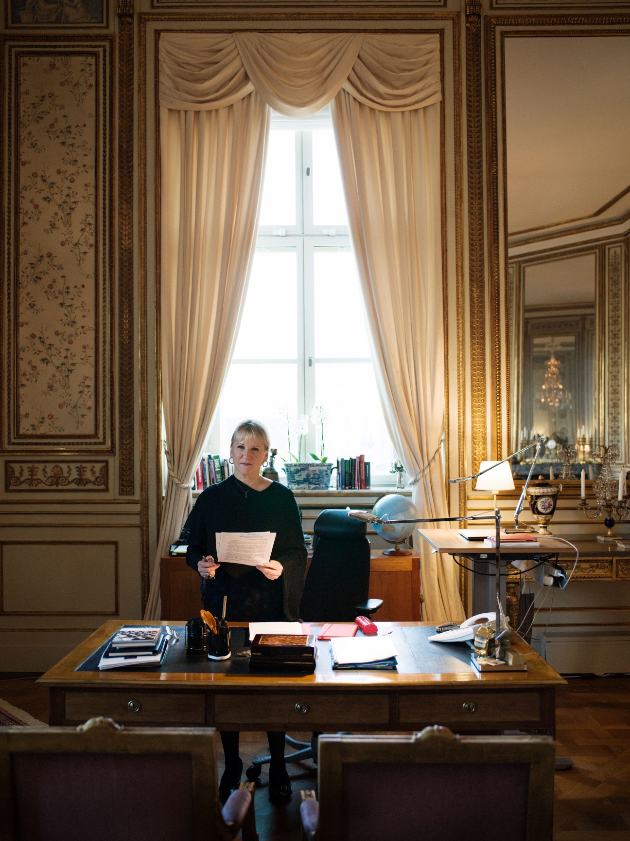 Margot Wallström, Sweden's foreign minister, standing in an ornate formal office with elegant furnishings and large windows.