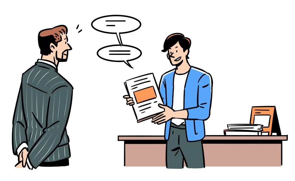 Two men having a business conversation in an office, one holding documents while the other listens