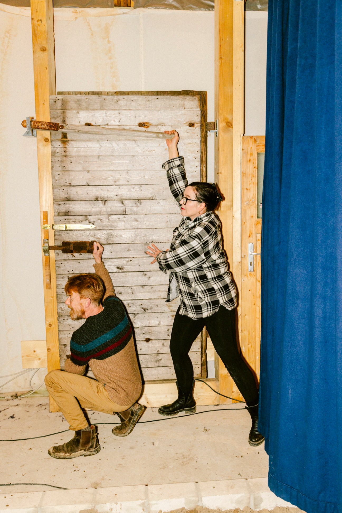 Burgis and Franziska Treutler with a creaky old door