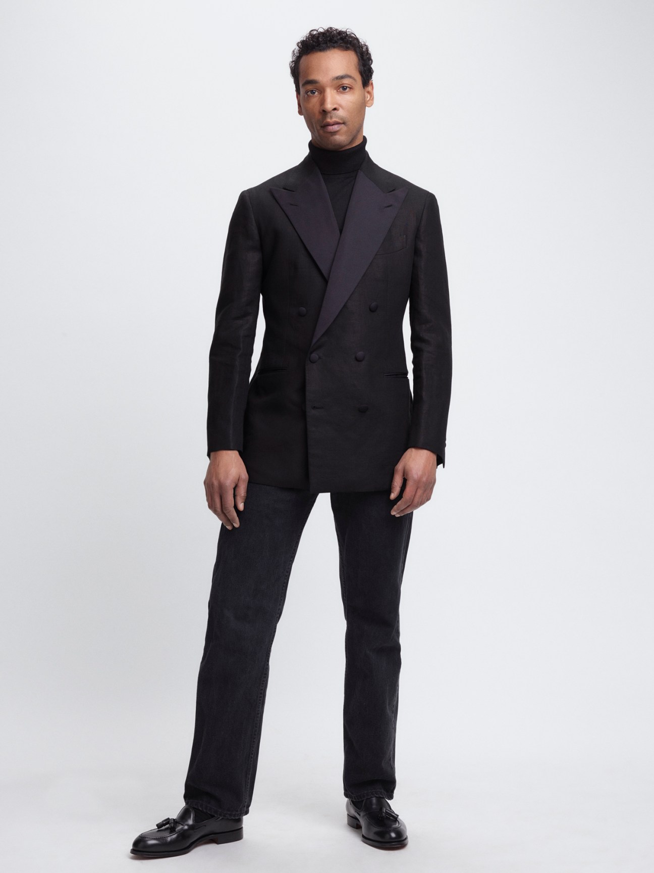 Model wearing linen and silk tuxedo jacket paired with casual black jeans