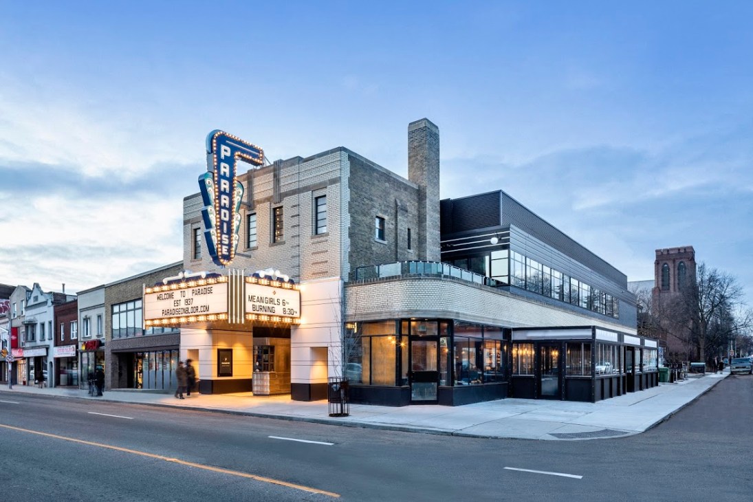 Exterior view of Toronto's Paradise Theatre showing restored art deco architecture with illuminated marquee and modern additions