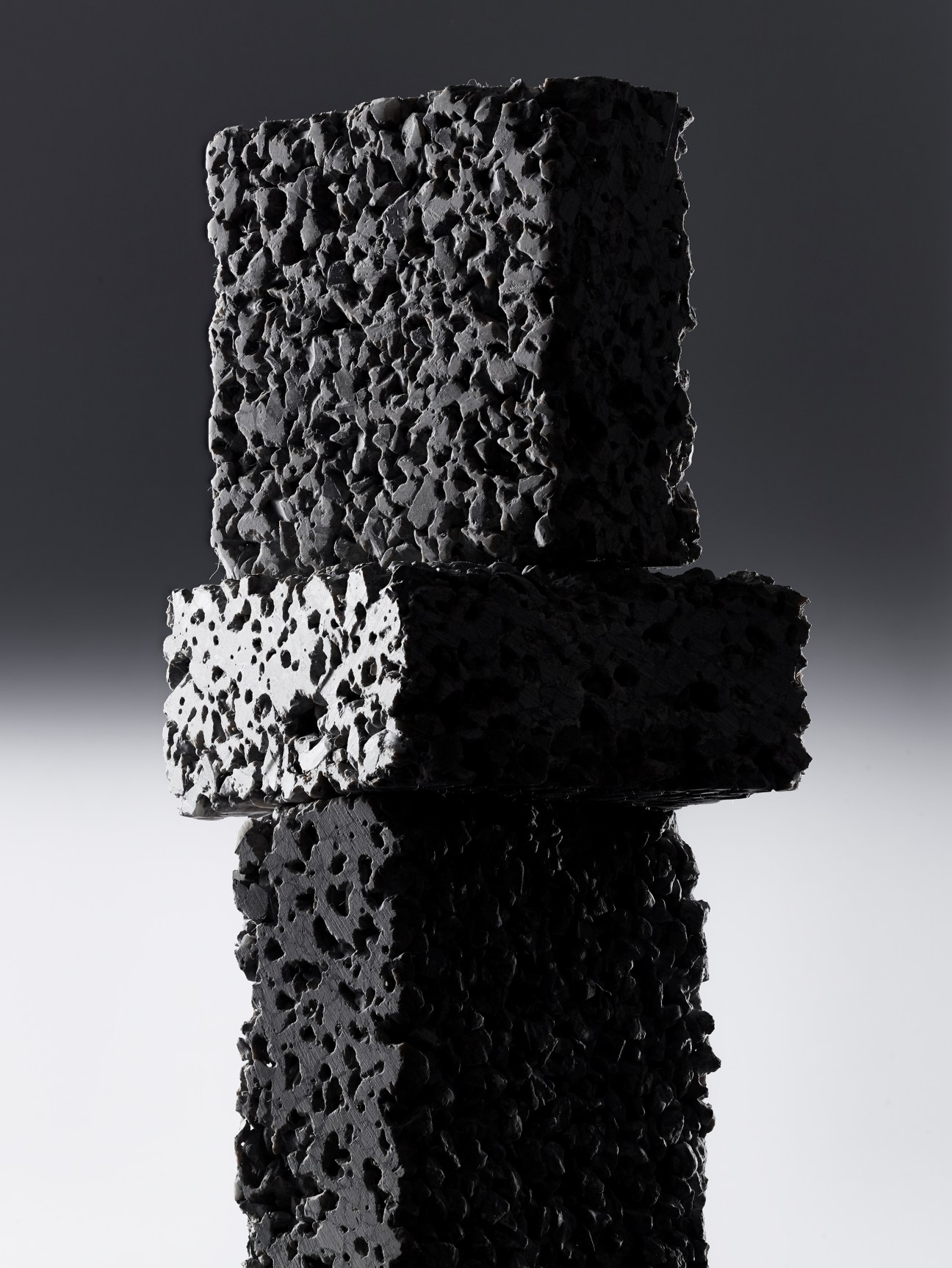 Stack of four EcoPact concrete blocks showing different textures and porosity levels