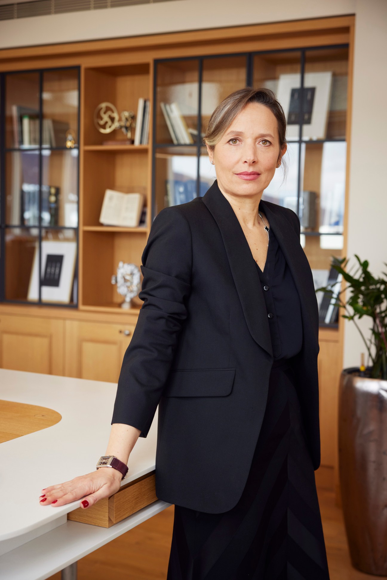 Catherine Rénier, CEO of Jaeger-LeCoultre, in black business attire standing in a modern office