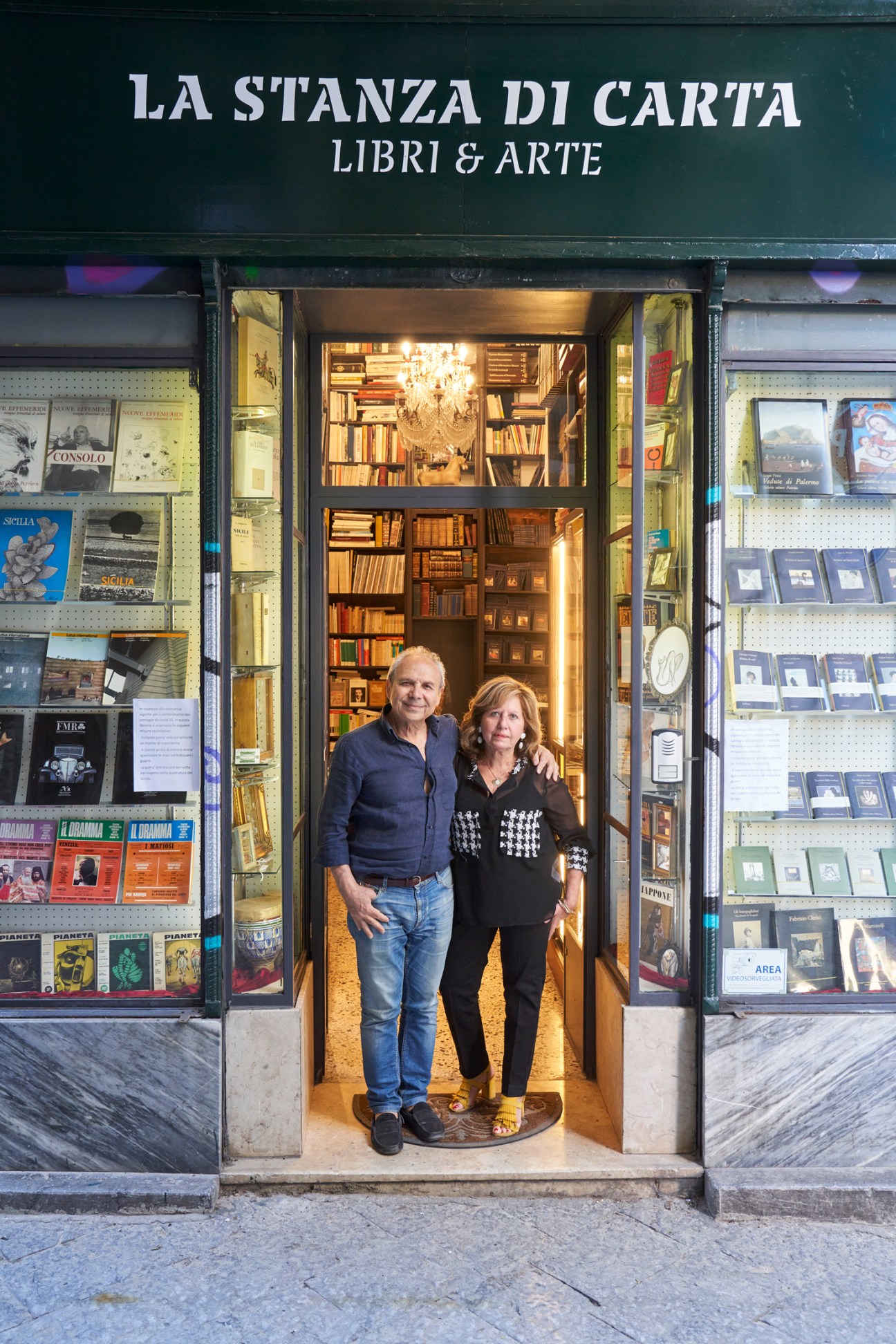 Piero Onorato and Lidia Peritore standing in the doorway of La Stanza di Carta bookstore in Palermo