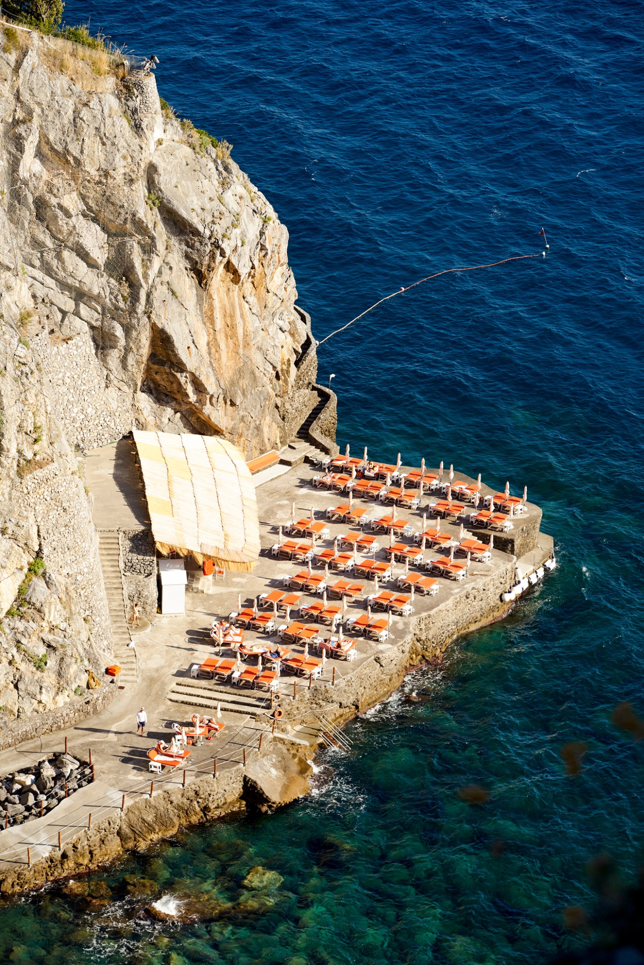 Iconic orange and white striped sun loungers at Il San Pietro hotel