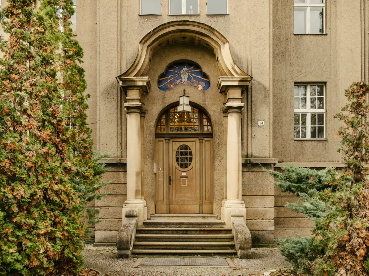 Ornate Art Nouveau building entrance with mosaic detail above the door.