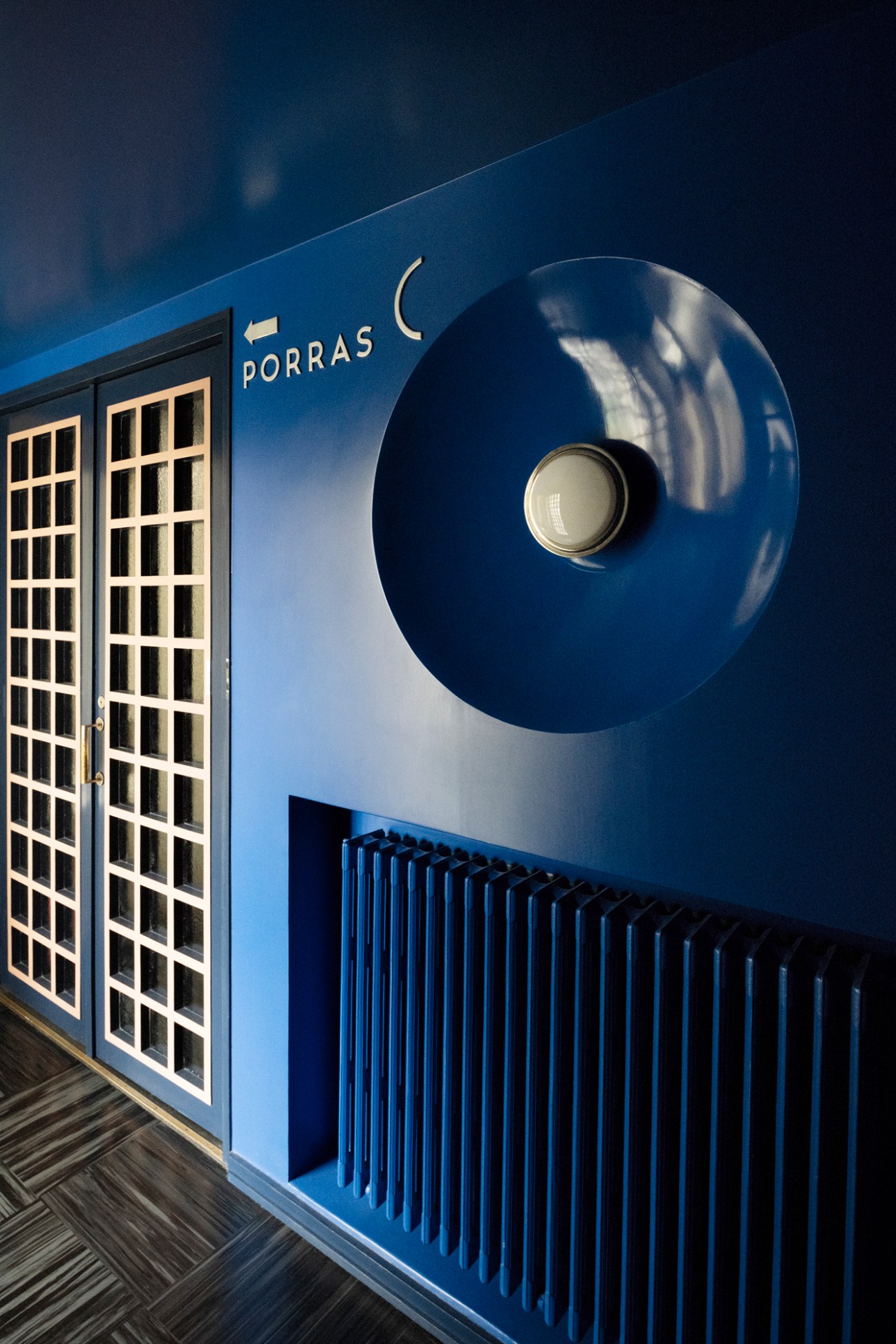 Interior common area at Lallukka artists' residence with blue walls, vintage furnishings and artwork
