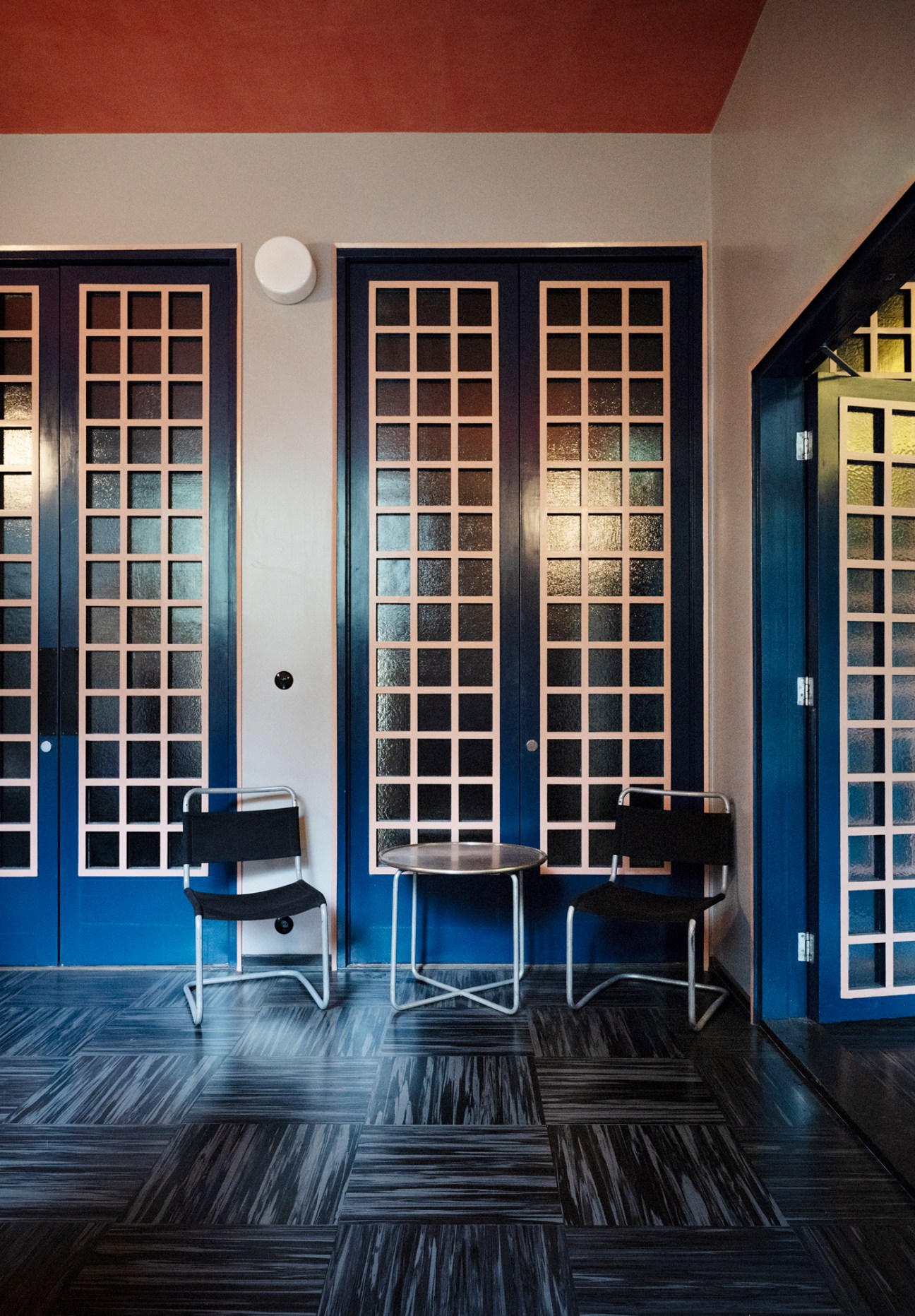 Bright blue entrance foyer of Lallukka artists' residence showing original 1930s architectural details