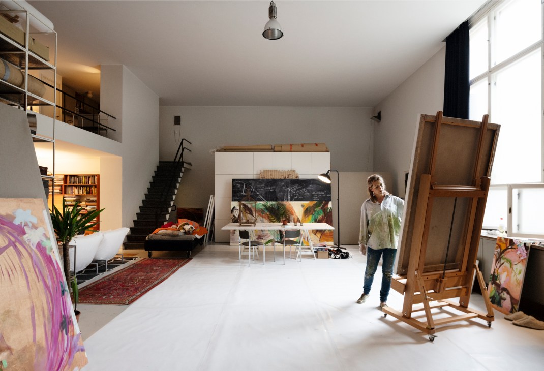 Fanny Tavastila working on a painting in her atelier