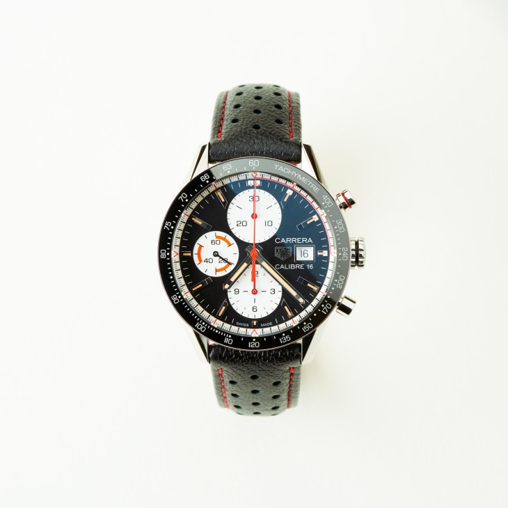 Tag Heuer Carrera Calibre 16 chronograph watch with black dial and leather strap.
