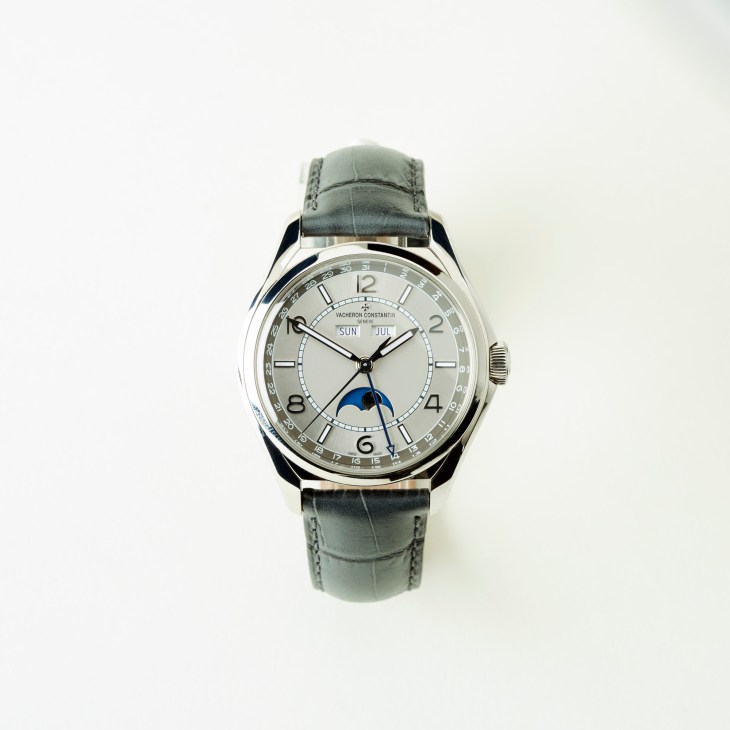Vacheron Constantin Fiftysix Complete Calendar watch with silver dial, moon phase, and grey leather strap.