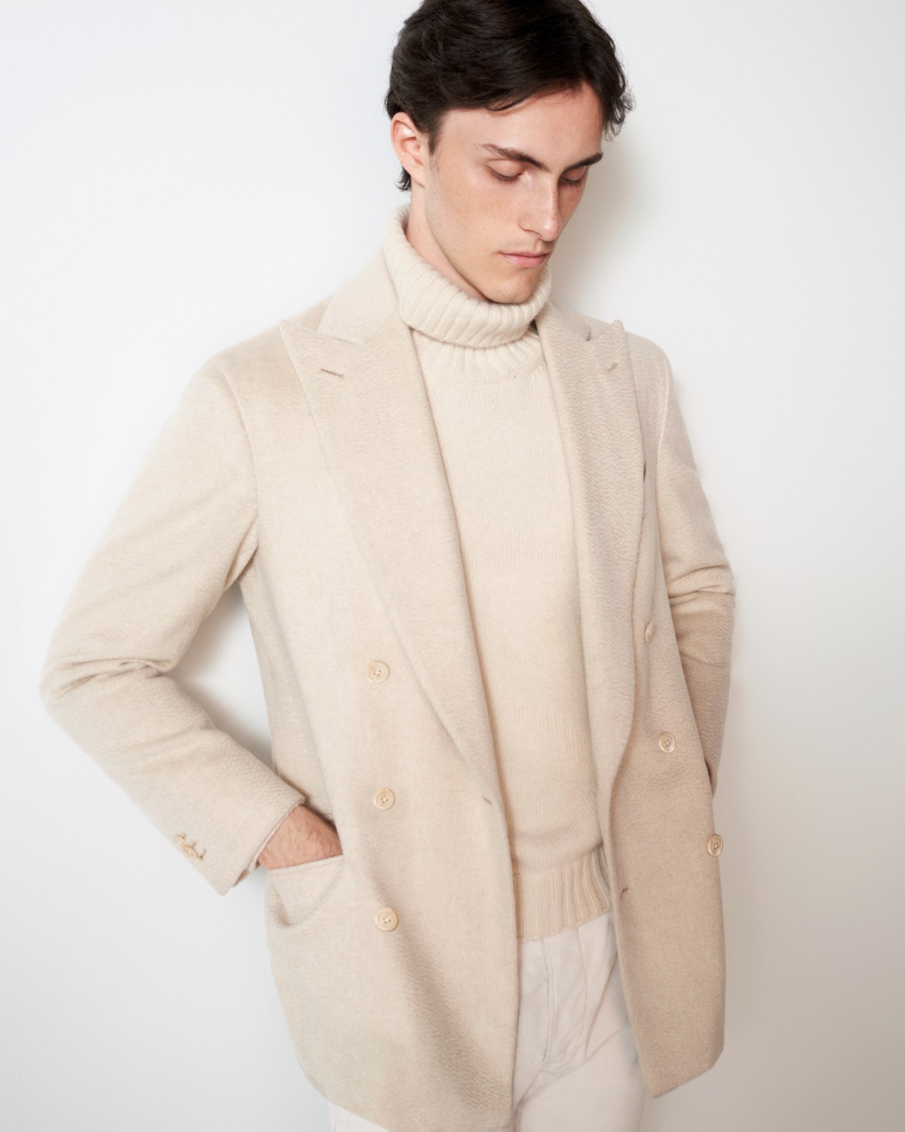 Model wearing light beige zibeline jacket with soft construction and natural drape by Saman Amel
