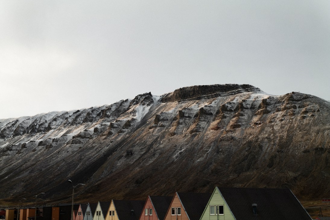 Mountain overlooking colourful houses in Arctic town of Longyearbyen