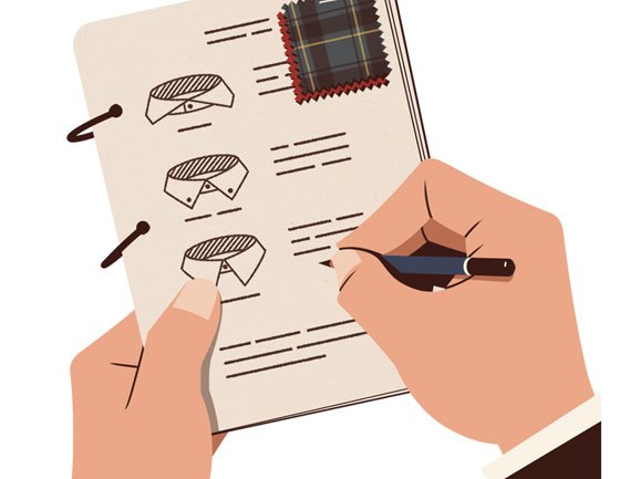 Hand writing in notebook with fabric swatches and pen