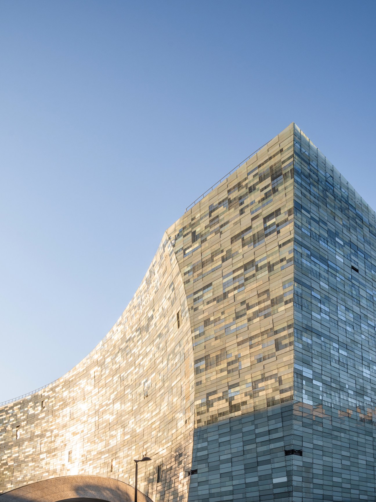 Modern glass building with pixelated facade design for Le Monde Group headquarters in Paris