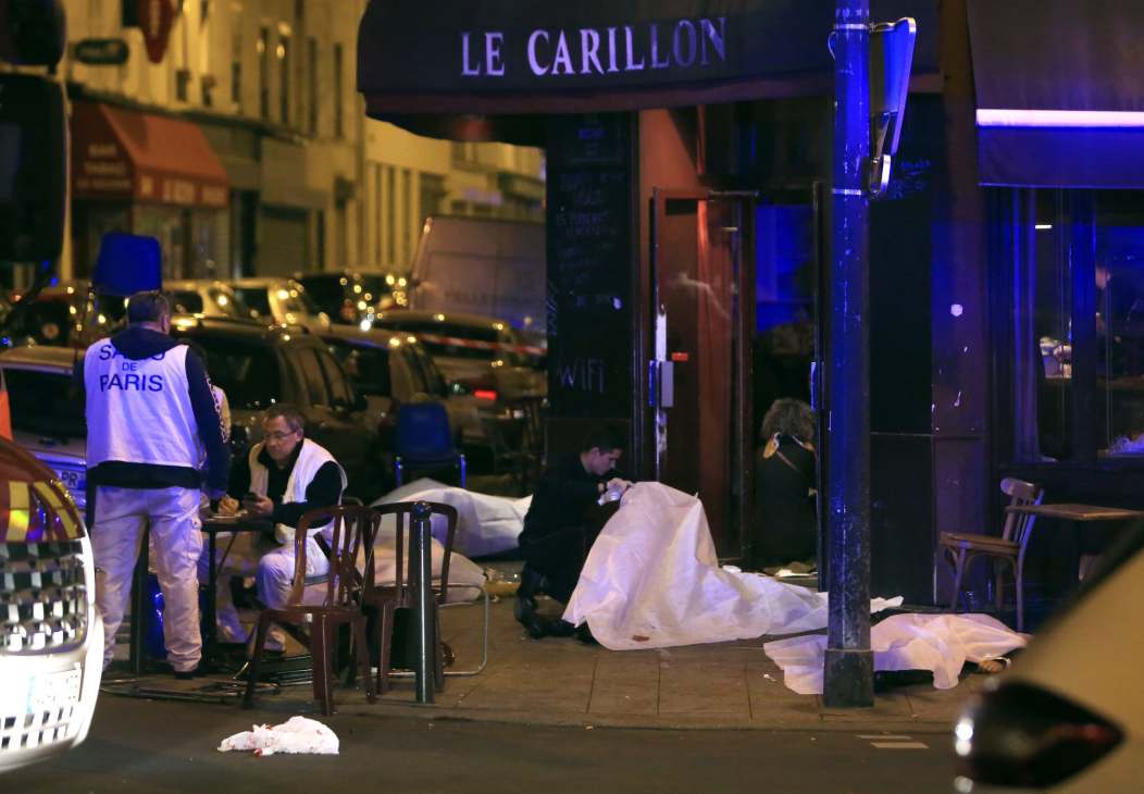 Emergency responders and covered bodies outside Le Carillon cafe after the November 2015 Paris terrorist attacks