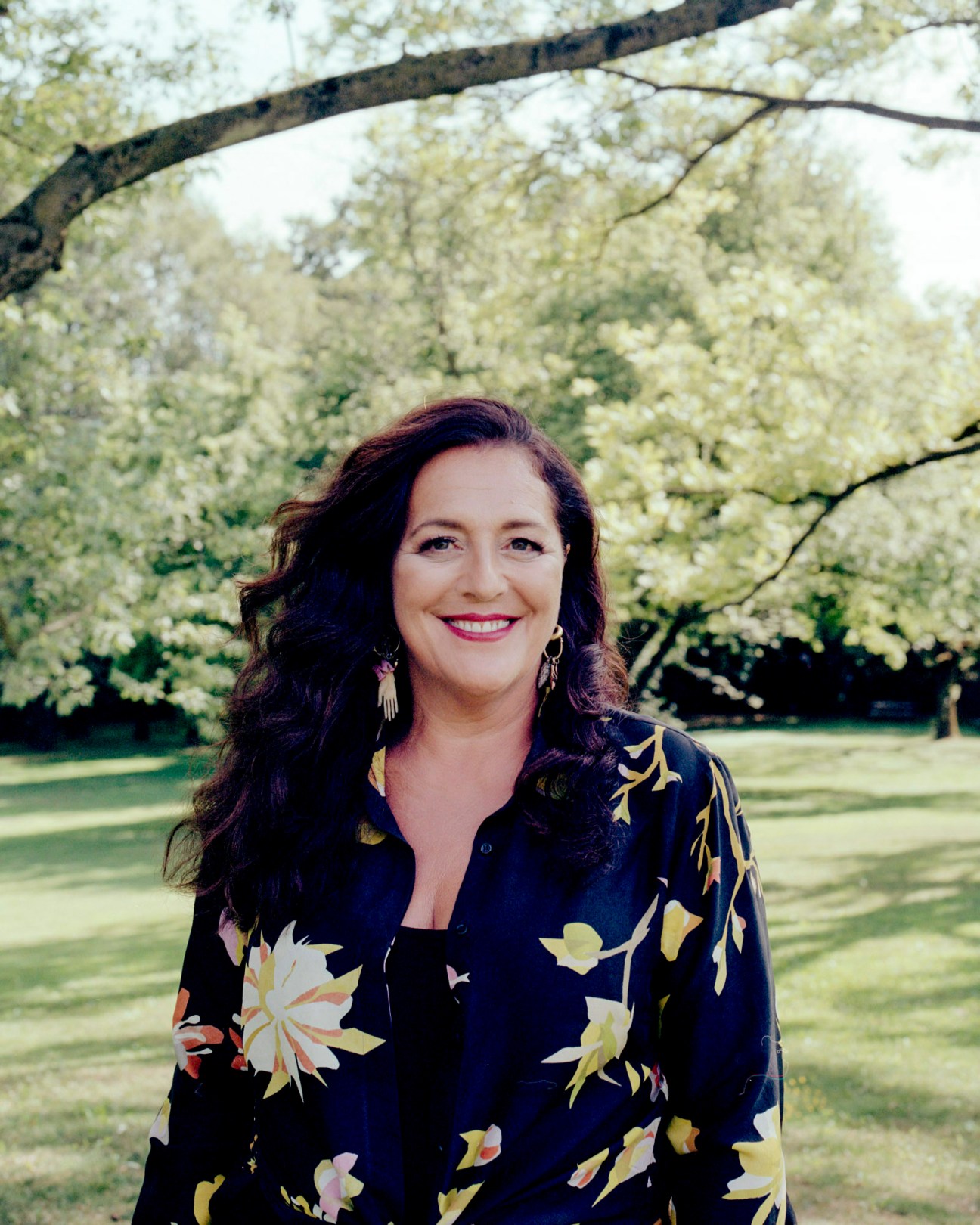Portrait of Angela Missoni, creative director of Missoni fashion house, wearing a dark floral shirt outdoors
