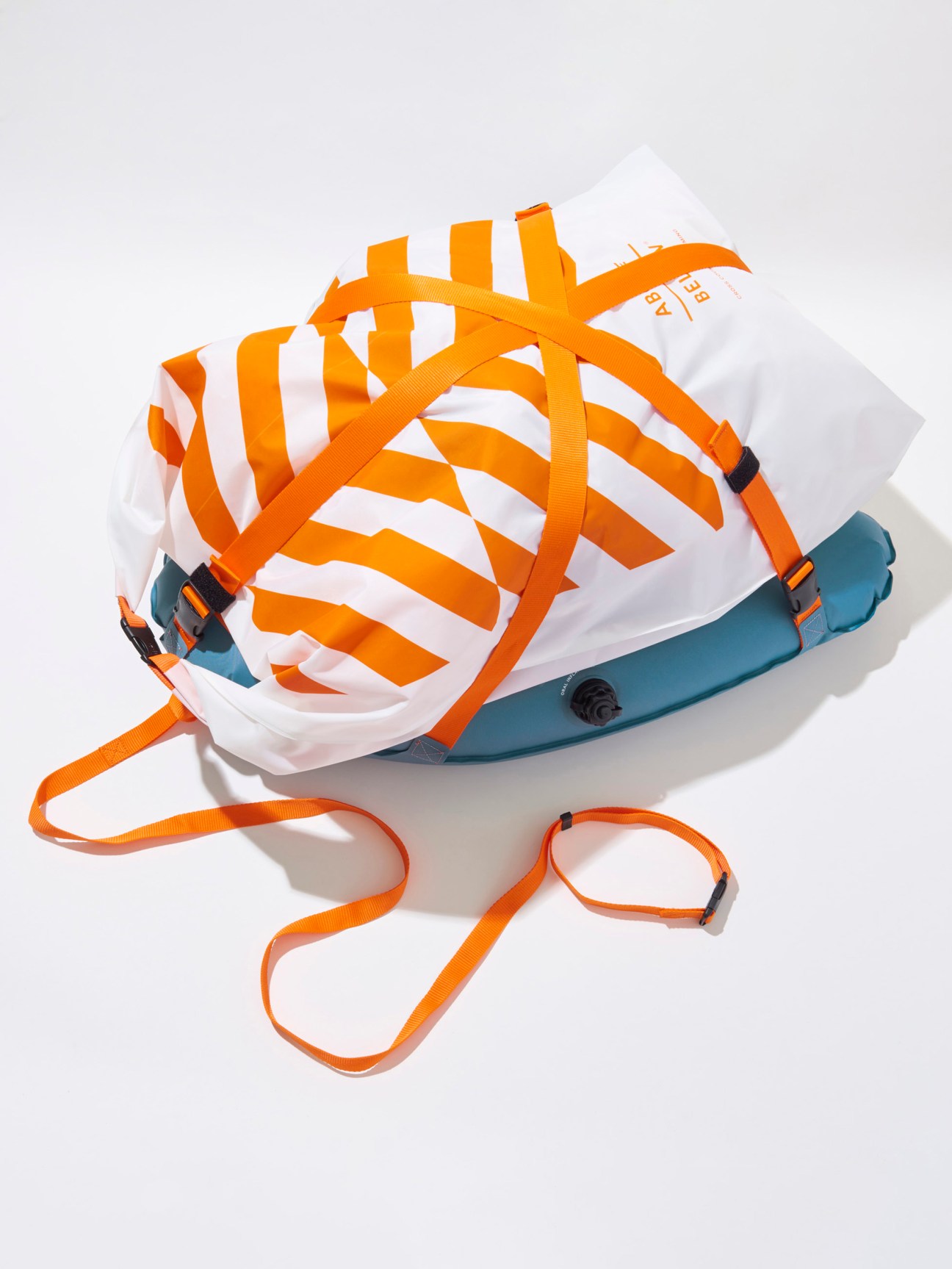 Above Below rucksack raft with orange straps and white striped design with teal inflatable bladder.