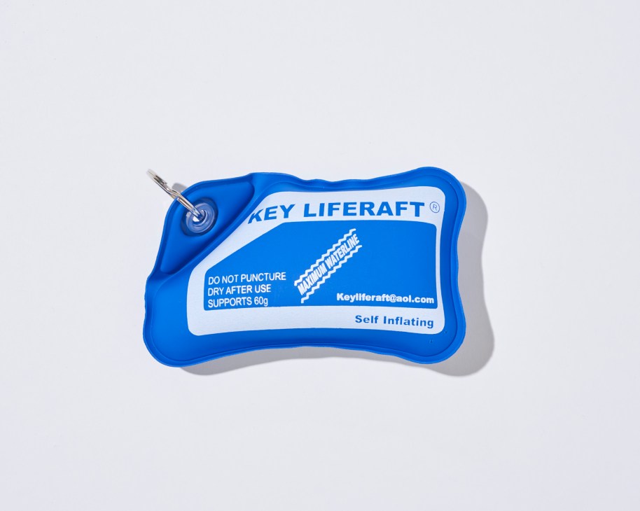 Blue Key Liferaft self-inflating keyring with instruction label and attached metal ring.