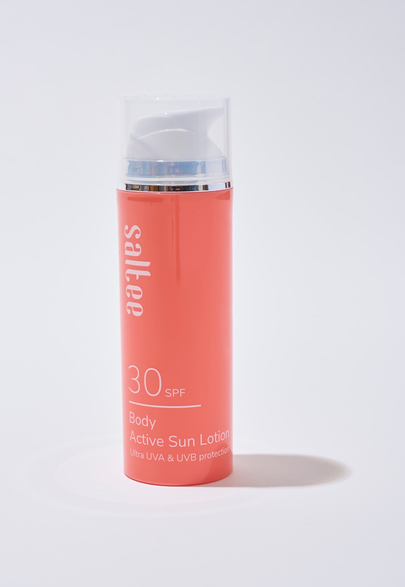 Saltee Body Active Sun Lotion SPF 30 in a coral-coloured pump bottle against a light background.