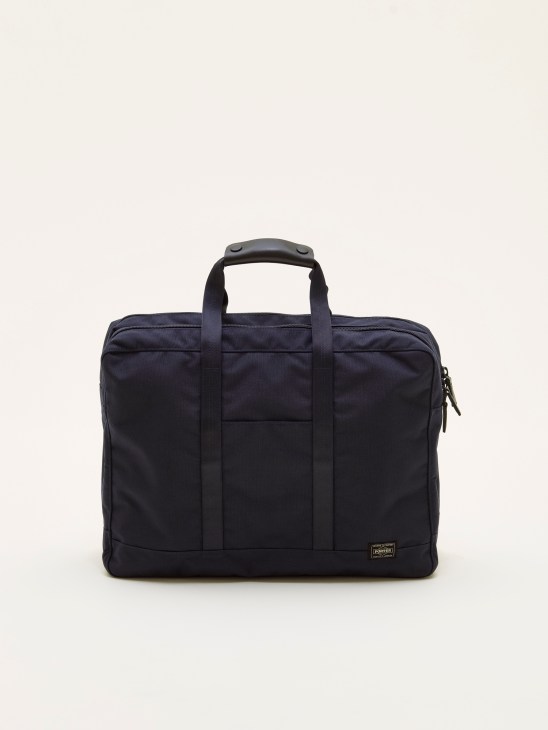 Navy Porter x Monocle Shorthauler bag with handles against a light background.