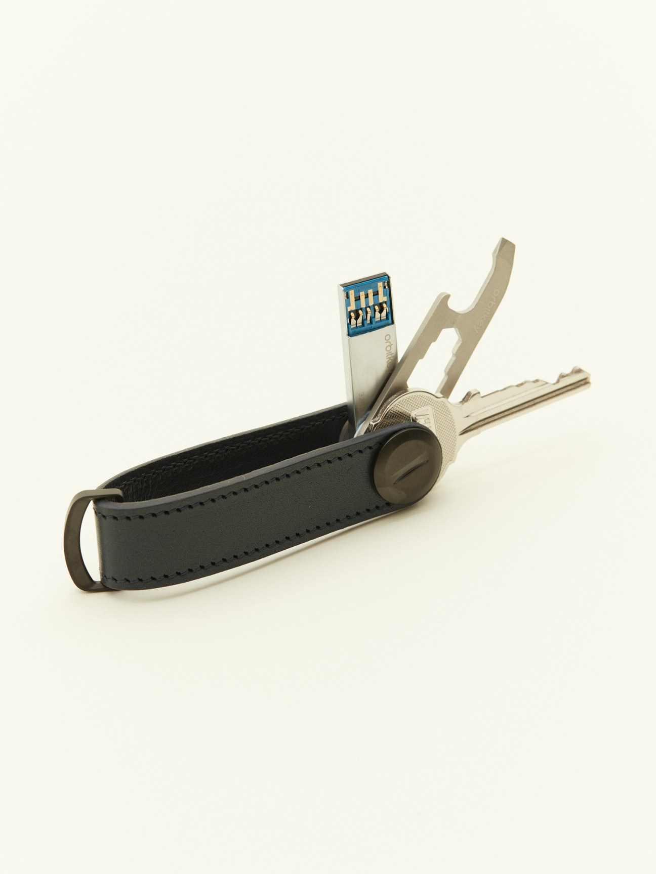 Orbitkey x Monocle key organiser with leather case holding keys and accessories.