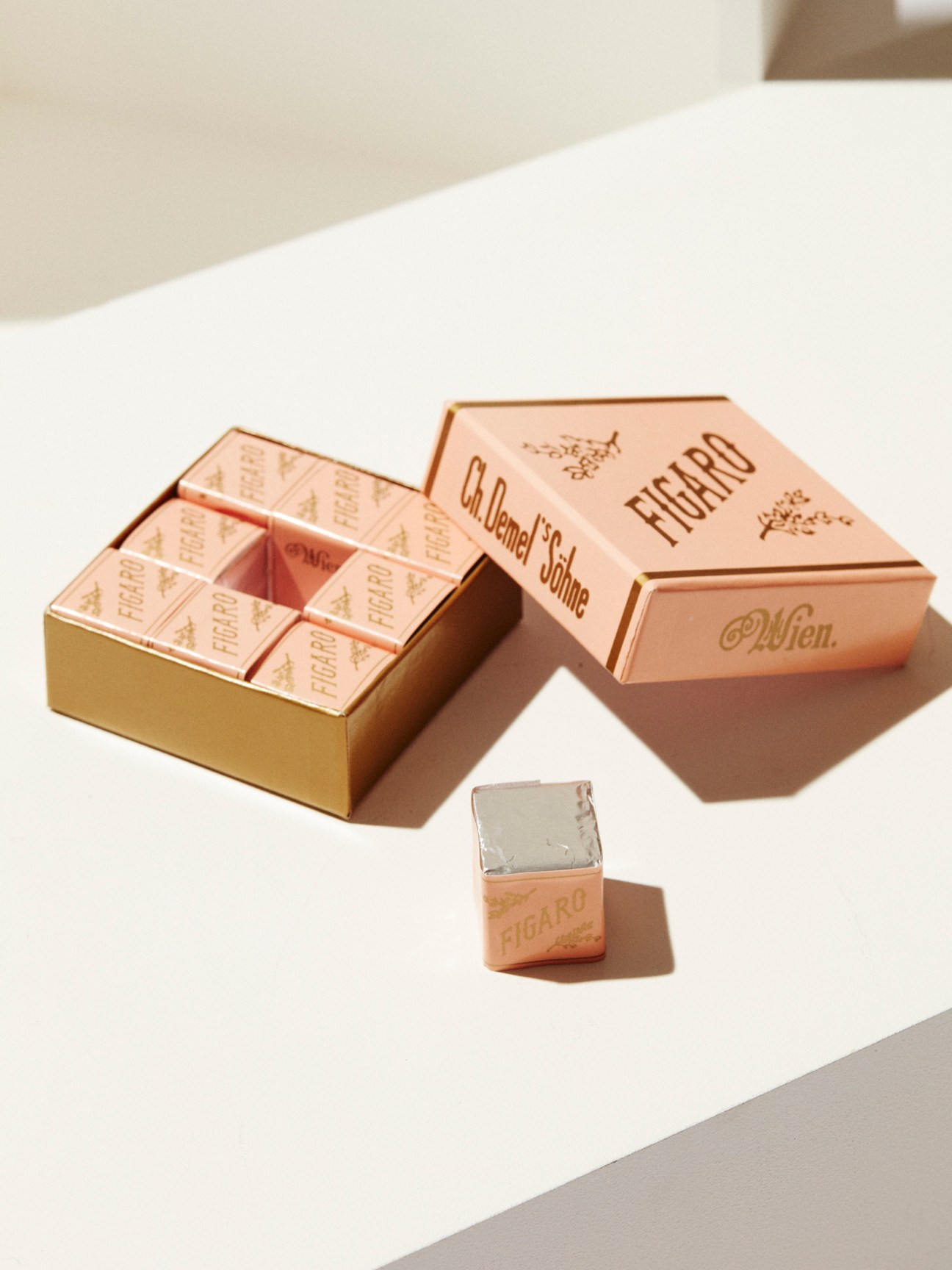 Demel chocolate boxes in rose gold packaging with individual chocolate squares